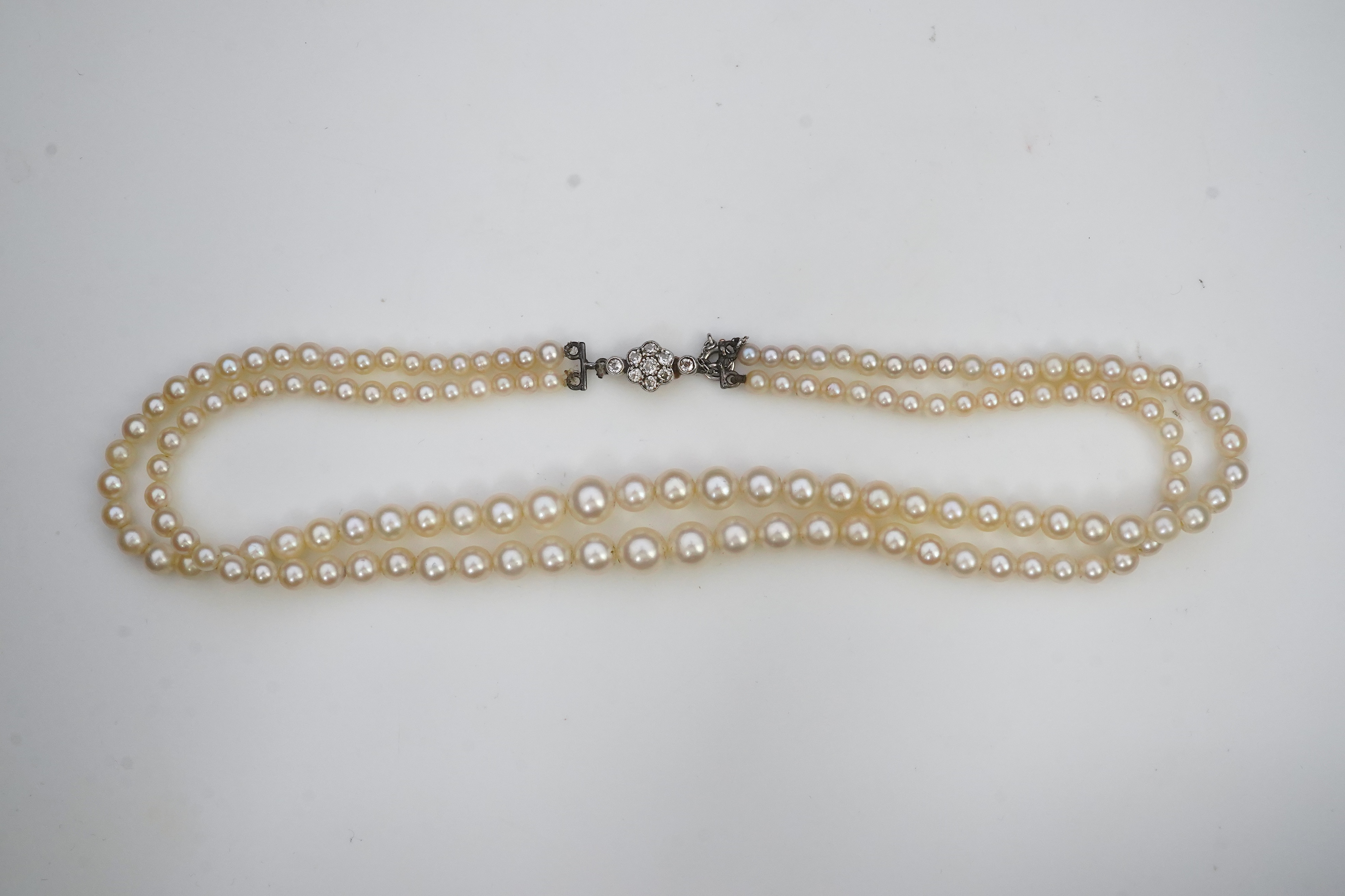 A cultured pearl and diamond necklace, early 20th century and later